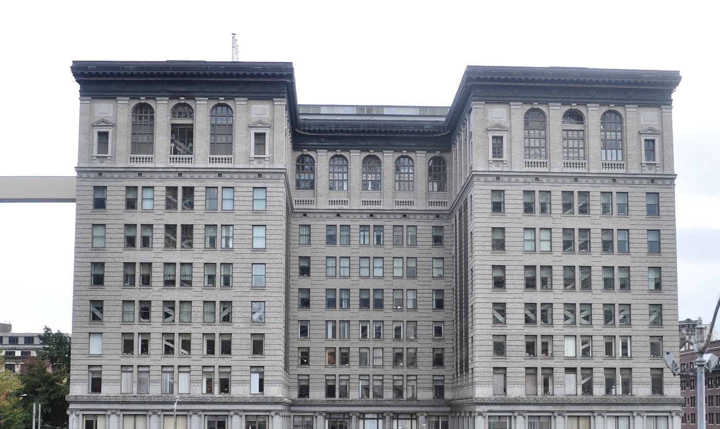 The same courthouse in 2018, photographed straight on: a pale stone facade with rows of windows and arched upper floors.